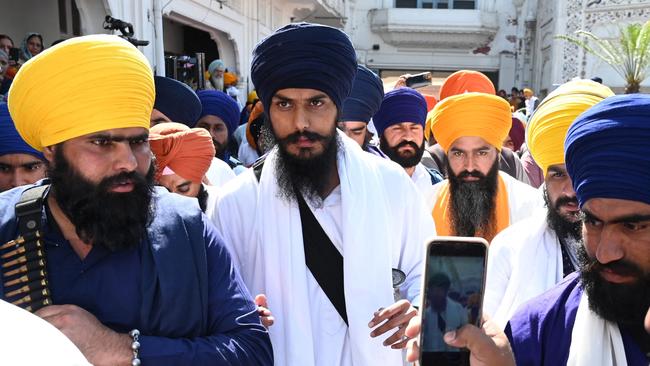 Amritpal Singh, centre, visits the Golden Temple in Amritsar. Picture: AFP