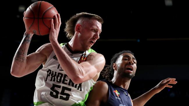 Mitch Creek takes on Obi Kyei during his return to Adelaide with the South East Melbourne Phoenix. Picture: Kelly Barnes (AAP).