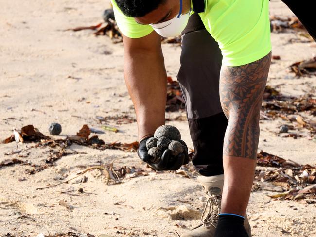 Coogee Beach has been closed until further after mysterious, black, ball-shaped debris was located washed along the length of the beach. Picture: NewsWire / Damian Shaw