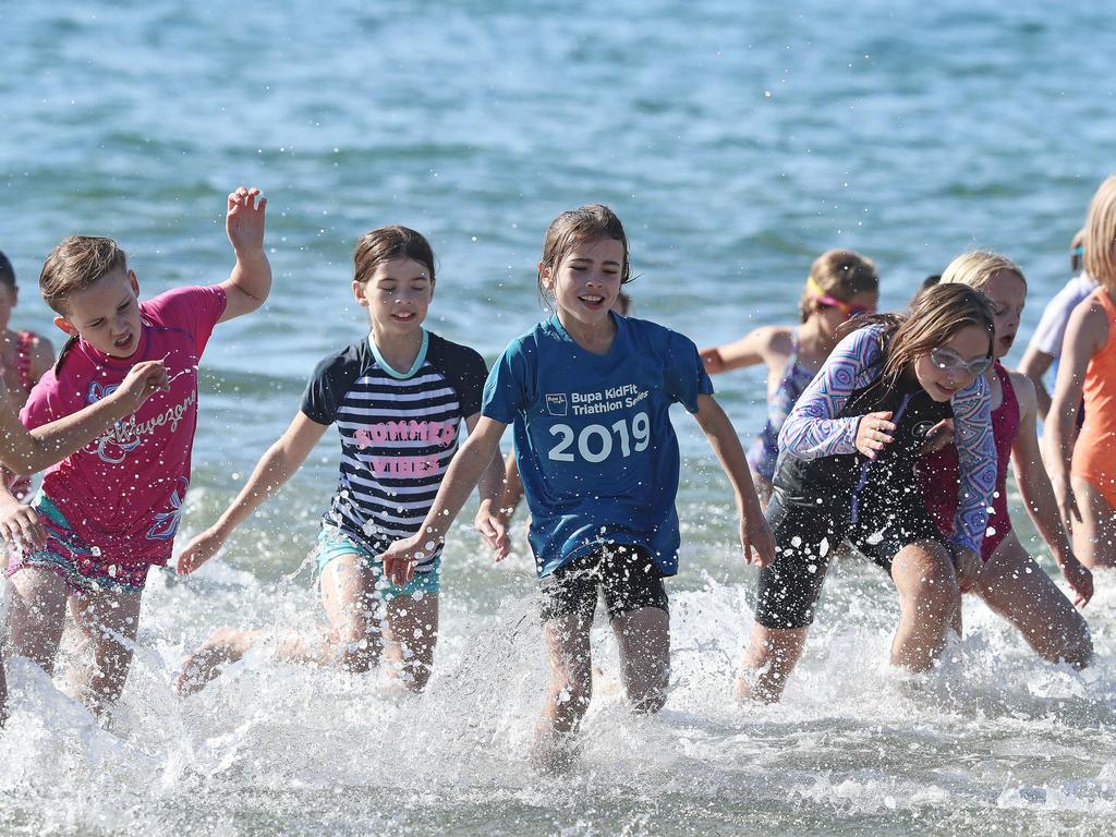 Participants in the 8 year old girls section finishing off their swim leg in the Bupa KidFit Series triathlon at Blackmans Bay Beach. Picture: LUKE BOWDEN