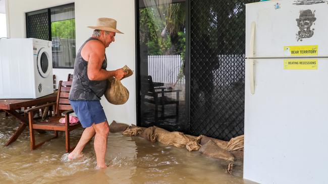 Townsville developer Brad Webb helps sandbag his daughter’s unit. Picture: Michael Chambers