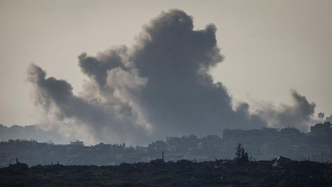 Smoke plumes rising from explosions above destroyed buildings in the northern Gaza Strip on January 18, 2025, a day before a ceasefire is set to take effect. Picture: AFP