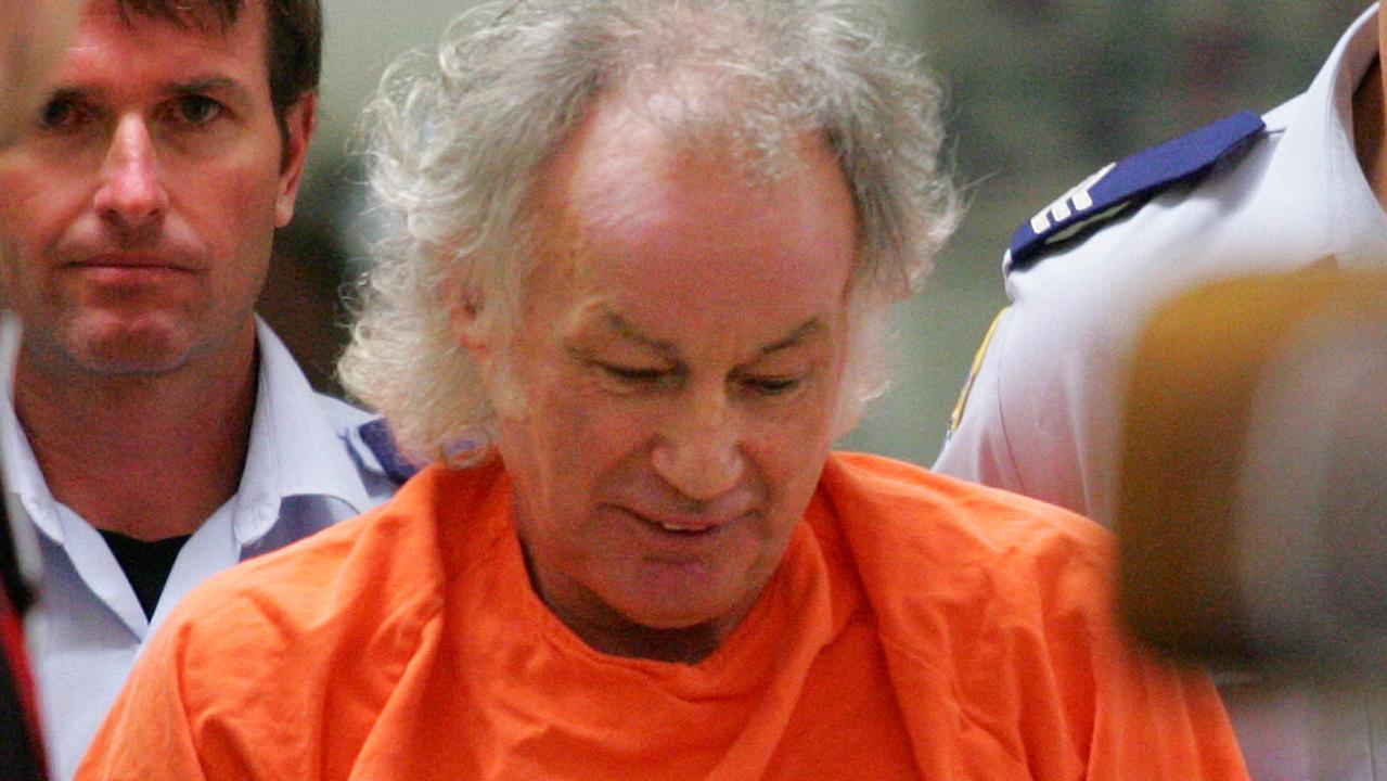 **News Awards Finalist Photograph of the Year** Convicted backpacker murderer Ivan Milat, dressed in his orange overalls, handcuffed and manacled with his left hand bandaged, is escorted from hospital by prison officers after getting treatment for his left pinky finger he severed and put in envelope to send to High Court, to go back to his cell in high security Goulburn Jail.