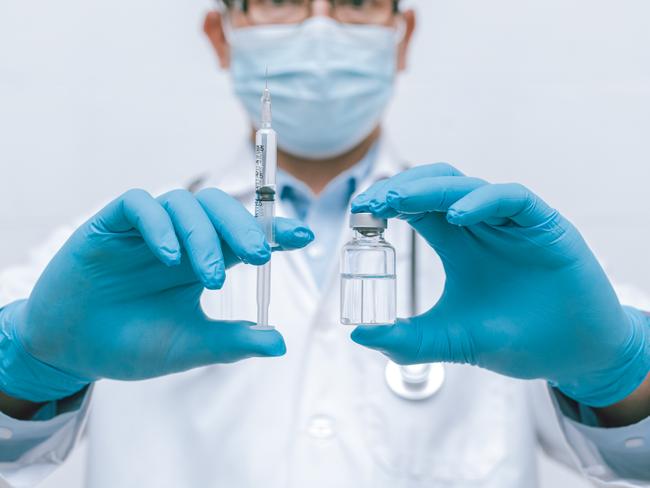 Doctor, nurse, scientist hand in blue gloves holding flu, measles, coronavirus, covid-19 vaccine disease preparing vaccination shot, medicine and drug concept.