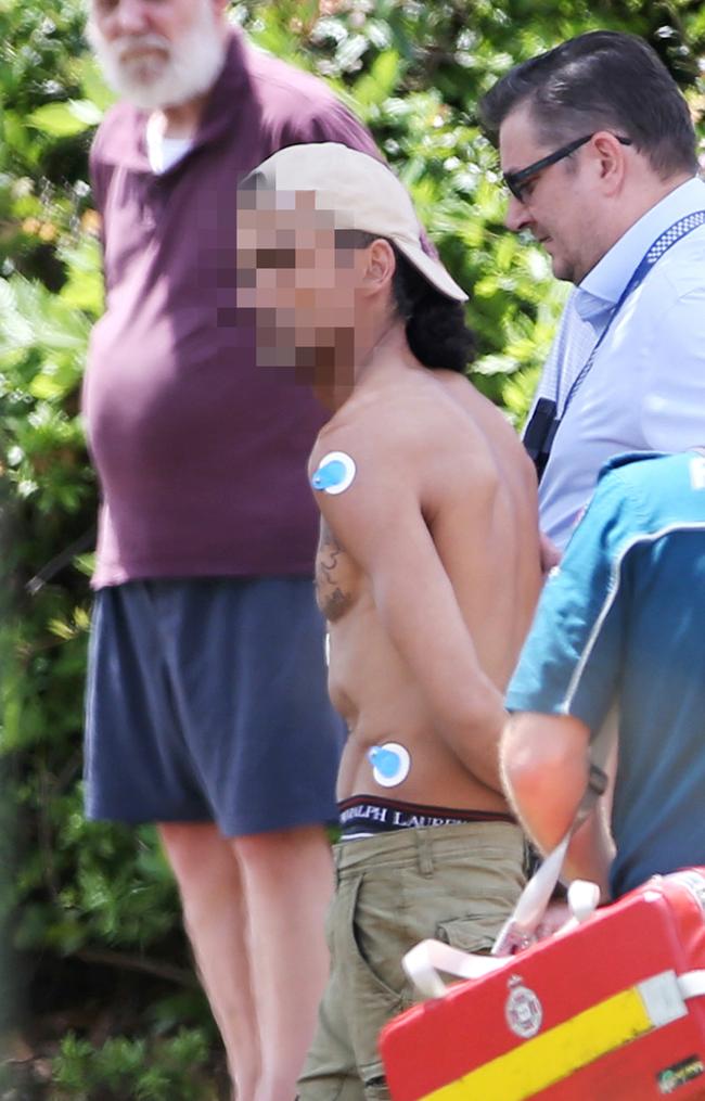 A man is led away after the Sunnybank siege. Picture: Tara Croser