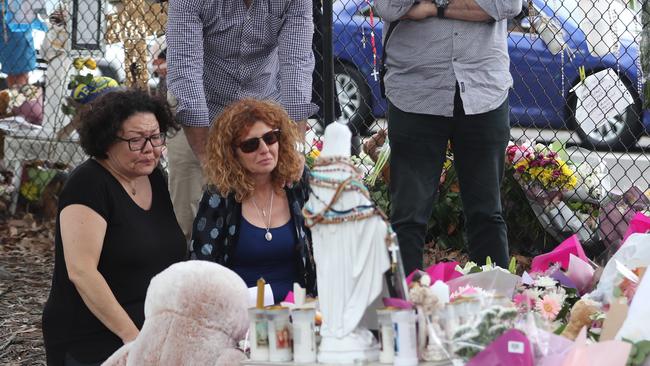 Members of the Sakr family gather around the memorial for Veronique Sakr while comforting mother Bridget Sakr (in blue). Picture: John Grainger