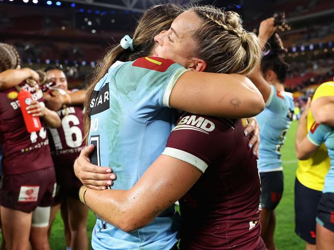 BRISBANE, AUSTRALIA - MAY 16: Taliah Fiumaono of the Blues and Lauren Brown of the Maroons embrace following game one of the 2024 Women's State of Origin series between Queensland and New South Wales at Suncorp Stadium on May 16, 2024 in Brisbane, Australia. (Photo by Hannah Peters/Getty Images)