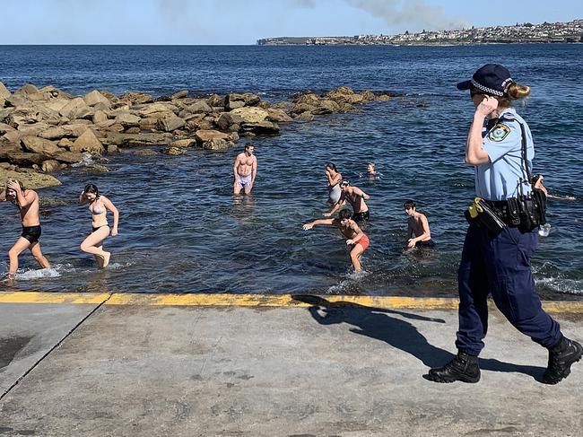 Swimmers are ordered from the water by police at Clovelly Beach last month. Picture: Ryan Pierse