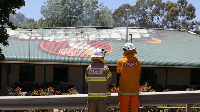 Firefighters inspect the damage. Picture: Dylan Coker