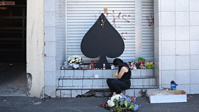 The vigil of flowers and candels grew throughout the morning. Picture: Adam Yip