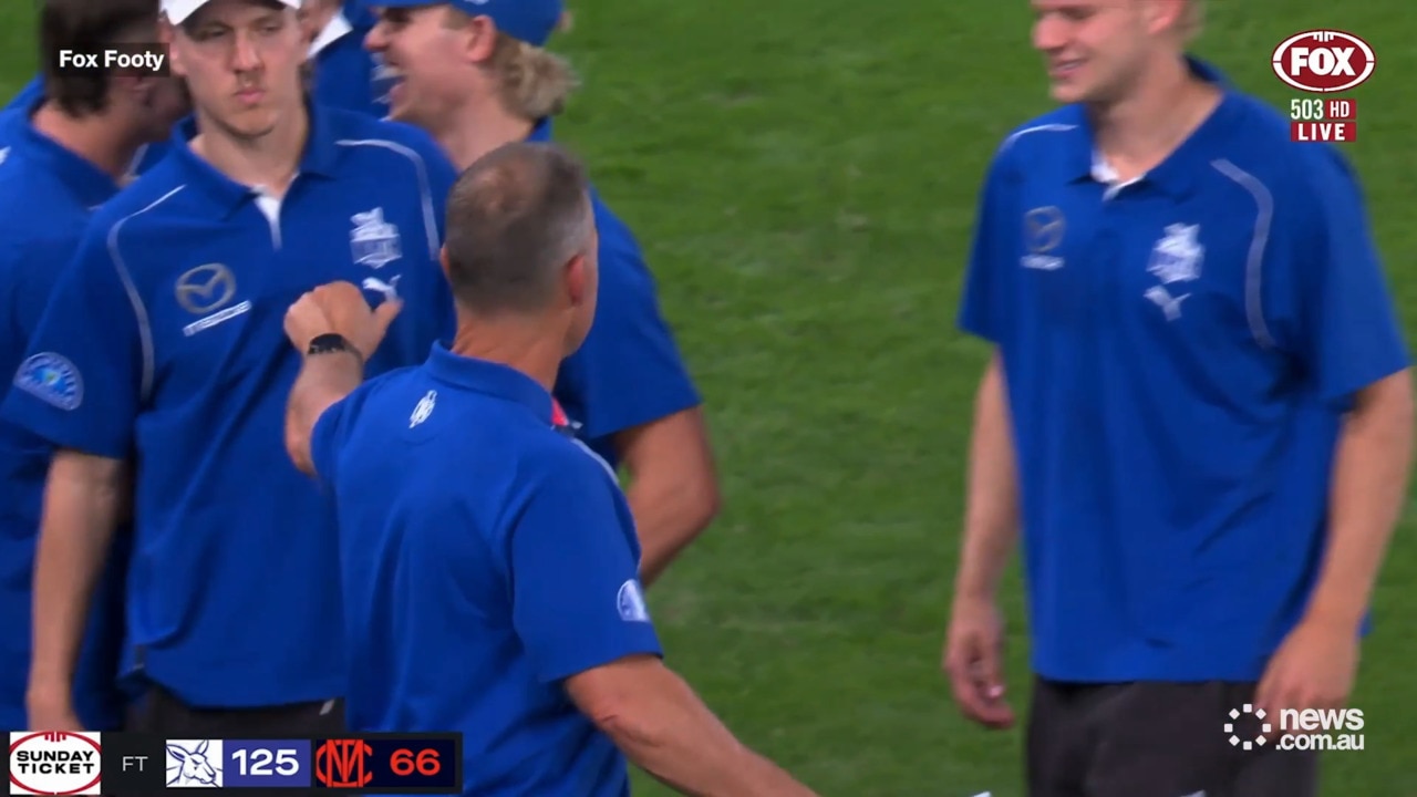 Kangaroos coach celebrates win with players on the sideline