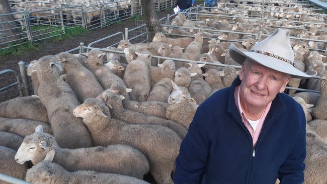 NSW agent Ian Geddes, from Elders, with the top pen of sucker lambs which made $238 at the Deniliquin prime sale on Tuesday. Picture: Jenny Kelly