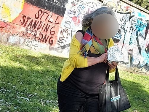 A Stand in the Park" protester in Newtown at the weekend, who reportedly filmed police and wrapped her phone in tin foil. Picture: Riso Winterbored