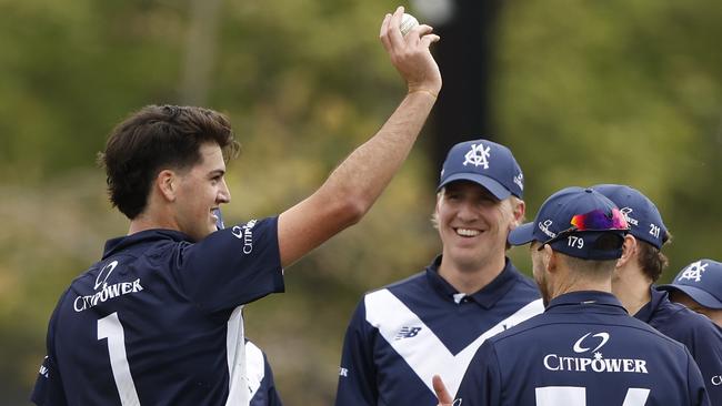 Sam Elliott (left) celebrates his maiden five-wicket haul for Victoria against Tasmania at the Junction Oval. Picture: Darrian Traynor / Getty Images