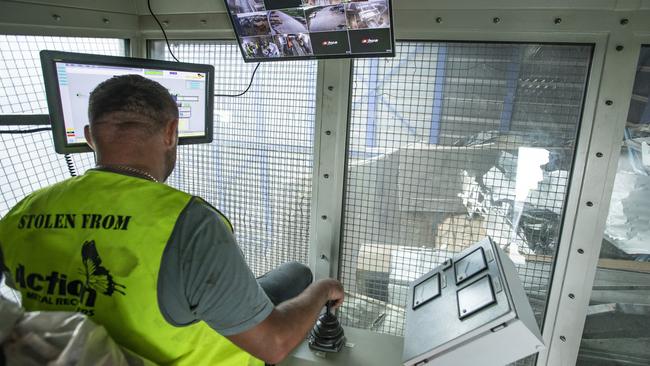 A worker at Wanless ovesees recycling of metal and other electronic equipment waste. Picture: Mark Cranitch