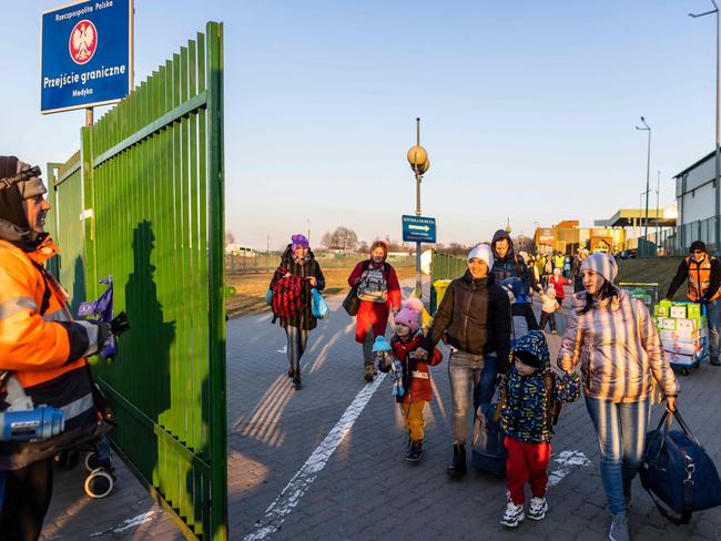 Refugees at the Medyka Polish-Ukrainian border crossing. More than three million Ukrainians have fled across the border, mostly women and children, according to the UN. (Photo by Wojtek Radwanski/AFP