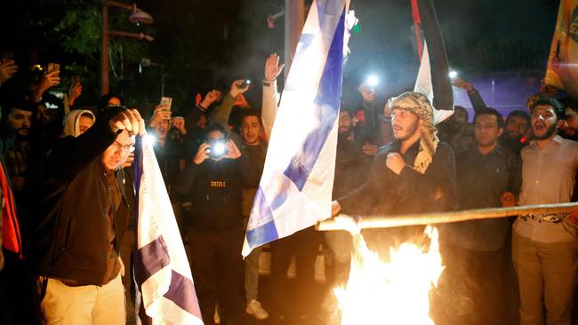 Iranian students and protesters burn Israeli flags as the conflict between Hamas and Israel rages. Picture: AFP