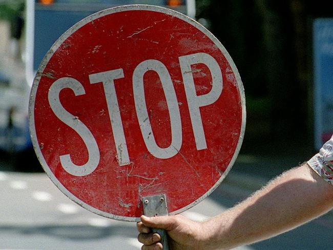 Road construction worker Grant Pomeroy holding Stop sign for traffic control in Sydney, 27/11/2000.