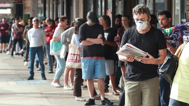 People queue for welfare in Sydney’s Marrickville. Picture: John Feder