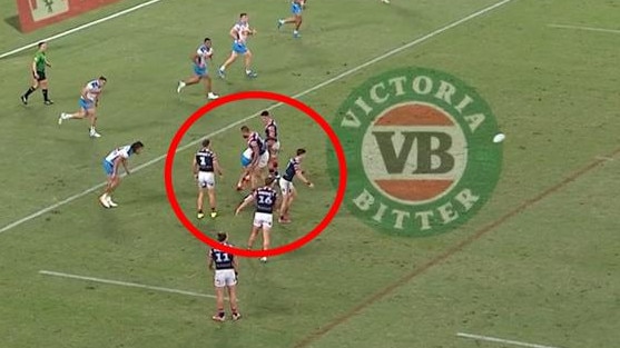 The Roosters form a wall as Sam Walker kicks a field goal.