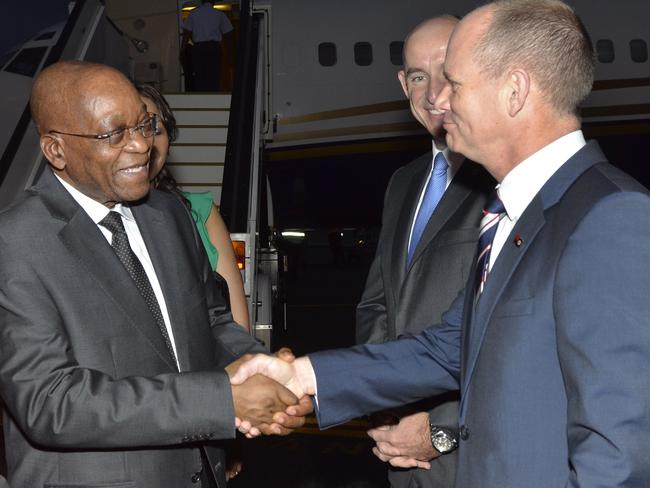 South Africa's President Jacob Zuma (left) is greeted by Queensland Premier Campbell Newman at Brisbane Airport this morning. Picture: AFP/Steven Holland