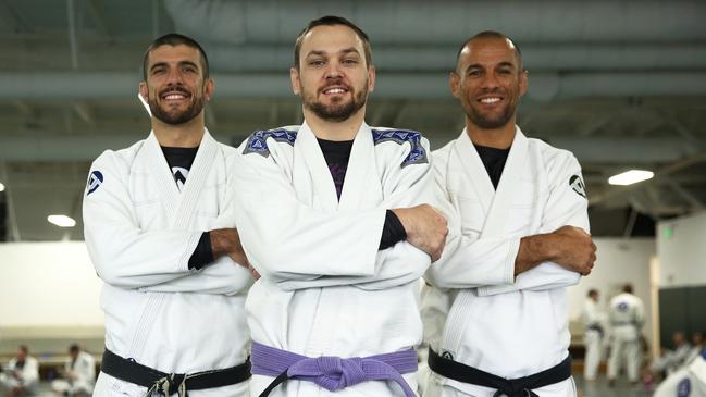 Gracie Jiu-Jitsu Camira owner and head instructor Shaun Harrison (centre) with Rener and Ryron Gracie.