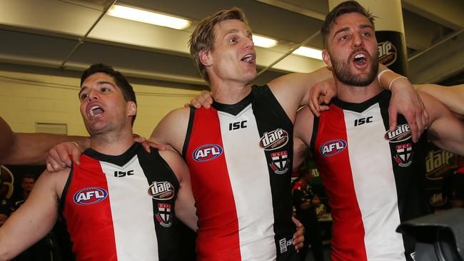 Leigh Montagna, Nick Riewoldt and Sam Fisher sing the song. Picture: Colleen Petch