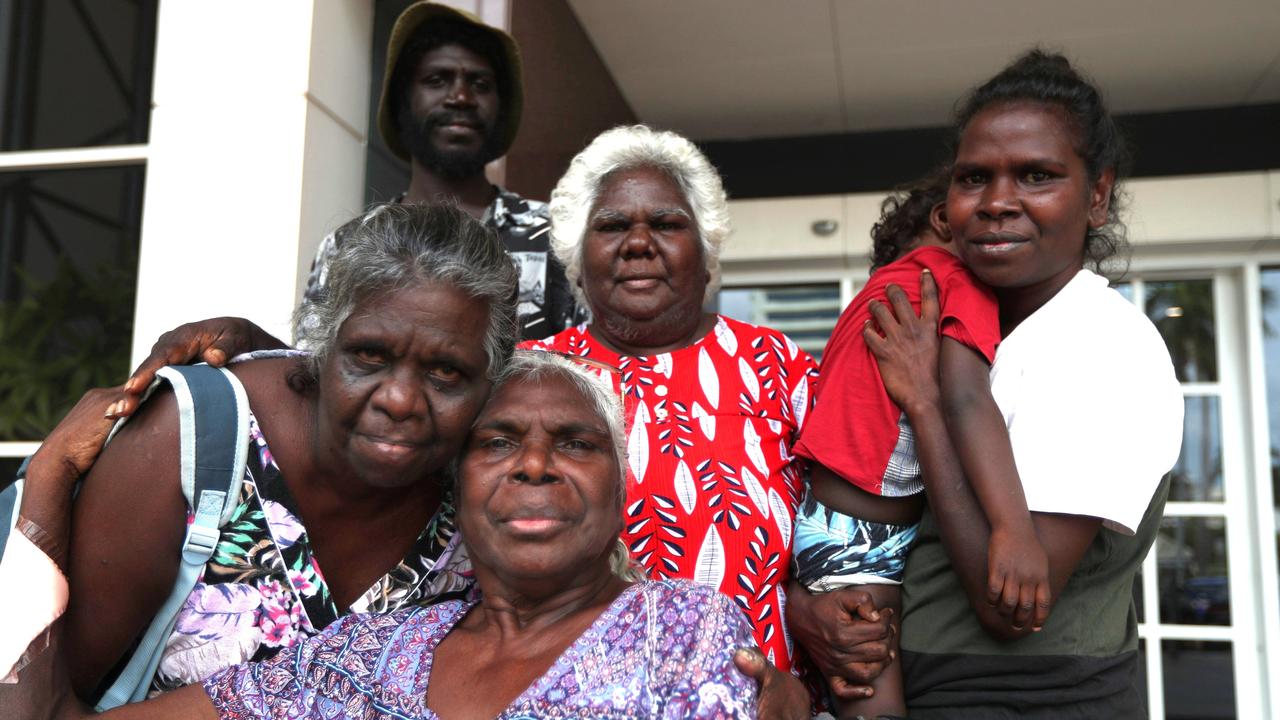 Judy Gungunbuy (seated), the mother of a 39-year-old Milingimbi man killed in a Rapid Creek car park brawl, with his aunt Joanne Garrawurra (left) and other family members outside the Supreme Court in Darwin. Picture: Zizi Averill