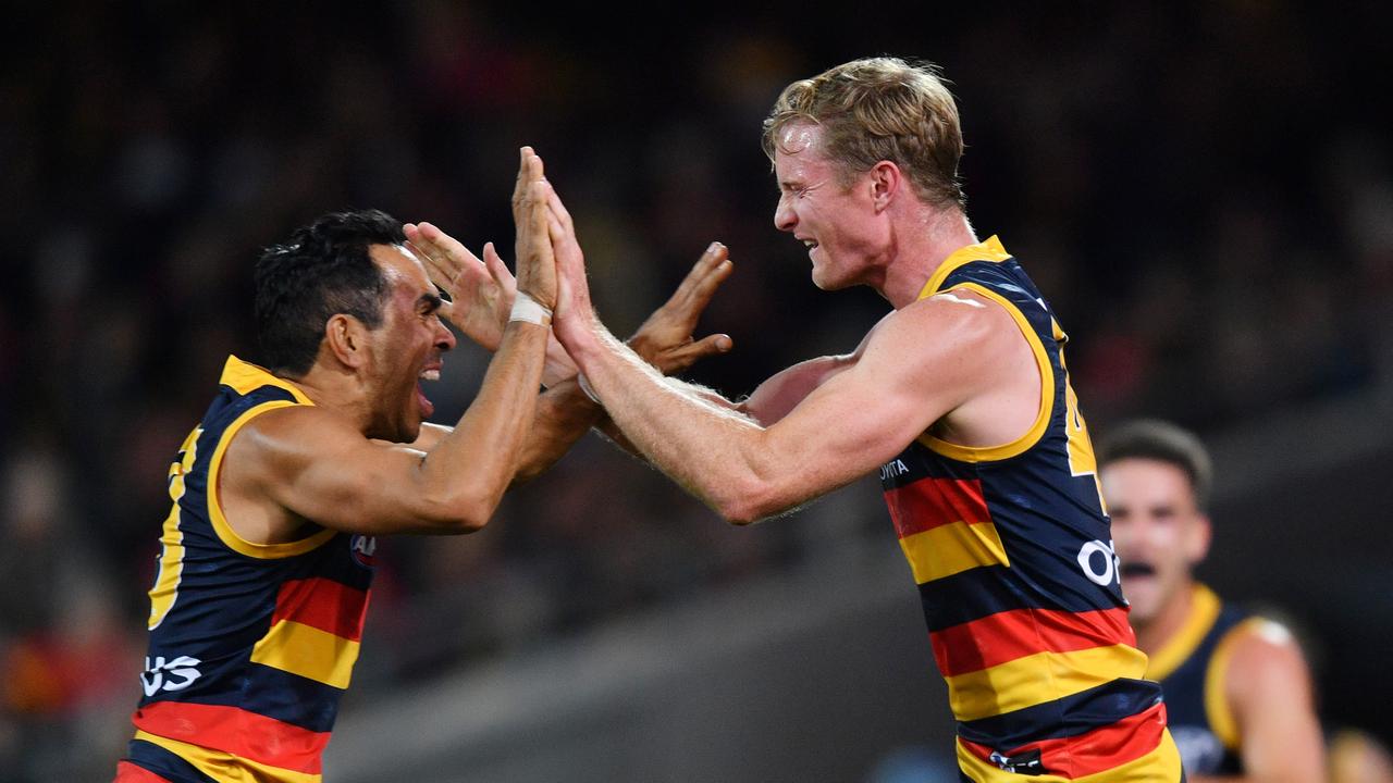 Alex Keath celebrates his first AFL goal with Eddie Betts. Picture: AAP Image/David Mariuz