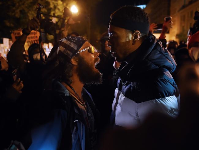 A Trump supporter clashes with a demonstrator at Black Lives Matter plaza across from the White House. Picture: AFP