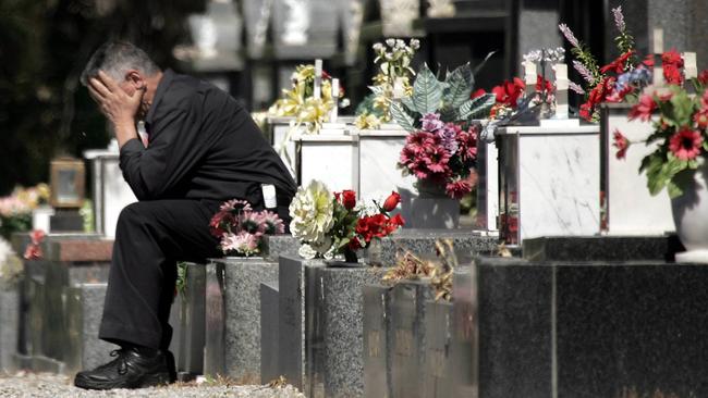 George Halvagis at the grave near where his daughter Mersina was murdered.