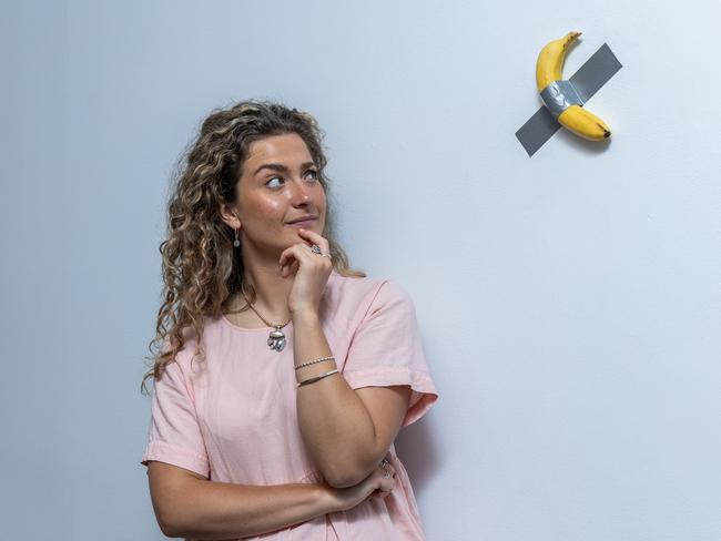 Zoe Avramidis inspects Comedian by Maurizio Cattelan at The NGV. Picture: Jake Nowakowski