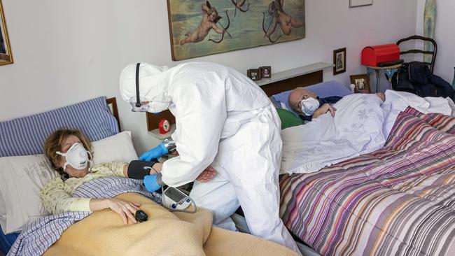 A member of the Italian Red Cross visits a patient during his round of home visits to COVID-19 positive patients in Bergamo, Italy. Picture: Marco Di Lauro/Getty Images