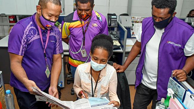 Post-Courier editor Matthew Vari, left, going over the Friday edition with, from second left, sports editor Simon Keslep, education reporter Leiao Gerega and sportswriter Jonathan Sibona at the newspaper’s headquarters in Port Moresby.