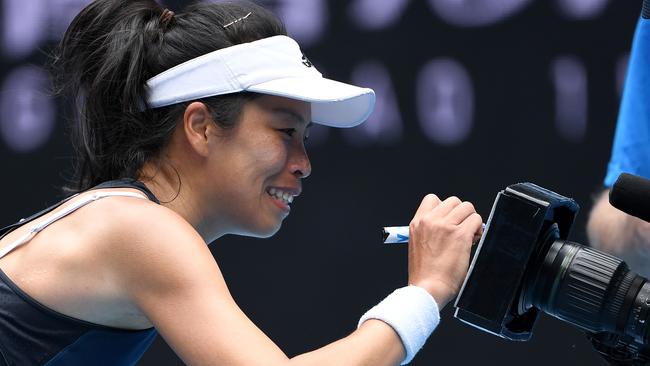 Taiwan's Su-Wei Hsieh signs her autograph on a TV camera after her stunning victory on Sunday. Picture: Paul Crock/AFP