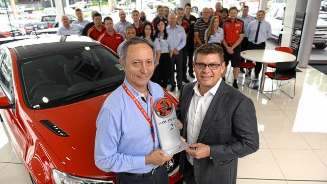 LONG JOURNEY: Llewellyn Motors dealer principal Wade Llewellyn (right) receives recognition for selling Holden vehicles for 25 years from GM Holden state manager Leo Leontaridis. Picture: Rob Williams