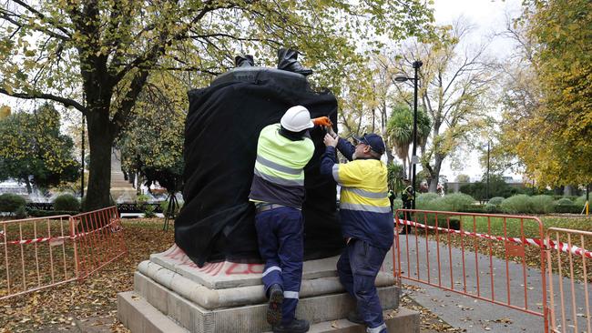 Council workers covering the remainder of the statue. The William Crowther statue in Franklin Square Hobart has been vandalised overnight resulting in the statue being removed from it's plinth and then removed by Hobart City Council. Picture: Nikki Davis-Jones