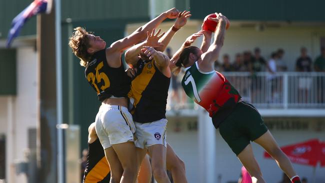 Pictured: Tigers Cooper Cartledge and Cutters Damien Hill in a marking contest. AFL Cairns 2024. Photo: Gyan-Reece Rocha