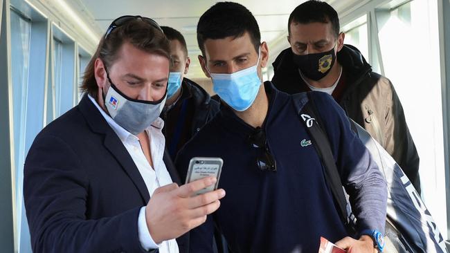 Novak Djokovic stops for a selfie after flying home. Picture: Reuters