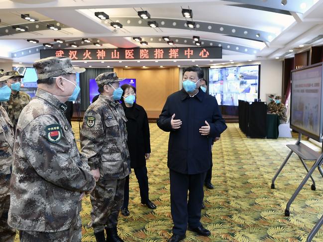 Chinese President Xi Jinping, right, is briefed about the Huoshenshan Hospital in Wuhan in central China's Hubei Province. Picture: AP