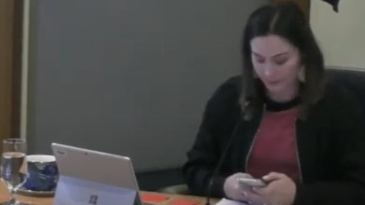 Acting Mayor Jo Westwood with phone in hand after councillor David Grace told her to call the police to get him to leave. Picture: Kingborough Council
