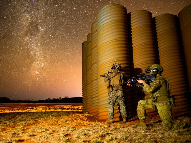 U.S. Marine Corps Lance Corporal Dexter Madrigal from Marine Rotational Force-Darwin 22 and Australian Army Private. Daniel Rochford from16th Battalion, Royal Western Australian Regiment, pose for a photograph under the stars at RAAF Base Curtin during Exercise Koolendong 2022. *** Local Caption *** Australian Defence Force soldiers and United States Marines have commenced Exercise Koolendong – the annual bilateral warfighting exercise in Northern Australia. The increased complexity of Exercise Koolendong 2022 reflects the commitments made at AUSMIN 2021 to enhance force posture cooperation. This exercise will enhance Australia-US interoperability and preparedness to respond to a regional security crisis. We are committed to an open, inclusive, and resilient Indo-Pacific region. The culminating exercise of the Marine Rotational Force - Darwin deploys forces by land, air, and sea to training areas in both Western Australia and the Northern Territory, including at Mount Bundy Training Area, RAAF Base Curtin, and Yampi Sound Training Area. Exercise Koolendong demonstrates joint capacity to deploy combined tactical teams across maritime and littoral environments over significant distances and in remote and austere environments.