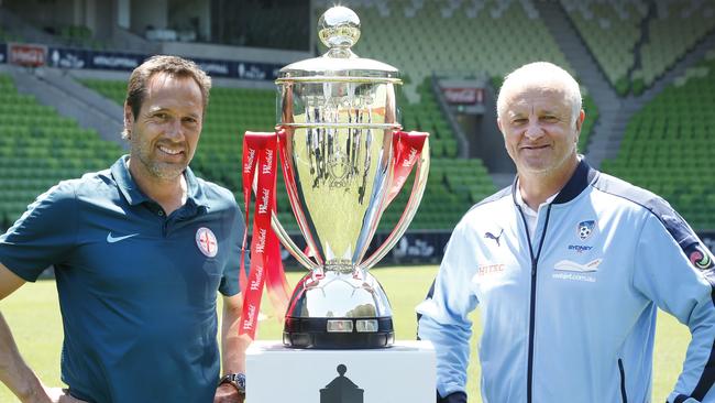 Melbourne City coach John van't Schip and Sydney FC coach Graham Arnold with the FFA Cup trophy at AAMI Park. Picture: David Caird