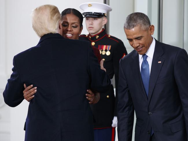 President Barack Obama stands at right as first lady Michelle Obama hugs incoming President Donald Trump at the White House in Washington on January 20, 2017. Picture: AP