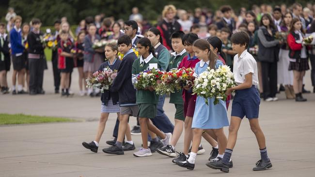 Students taking wreaths to the Eternal Flame.
