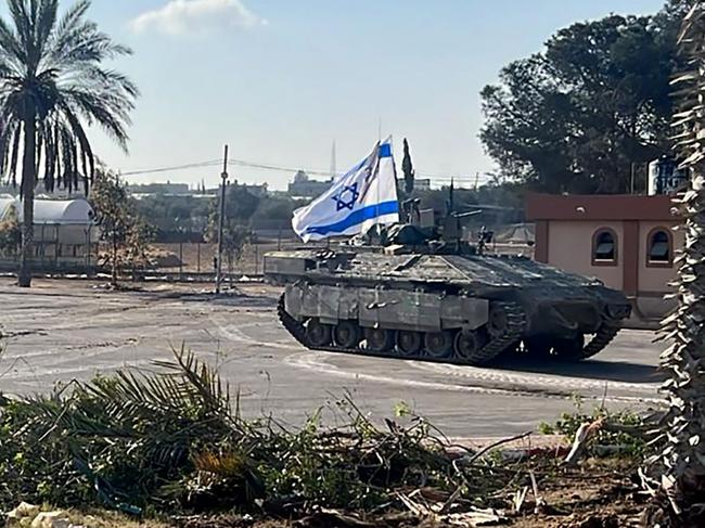 This handout picture released by the Israeli army shows the 401st Brigade's combat team tanks entering the Palestinian side of the Rafah border crossing between Gaza and Egypt in the southern Gaza Strip on May 7, 2024. The Israeli army said it took "operational control" of the Palestinian side of the Rafah border crossing on May 7 and that troops were scanning the area. (Photo by Israeli Army / AFP) / === RESTRICTED TO EDITORIAL USE - MANDATORY CREDIT "AFP PHOTO / Handout / Israeli Army' - NO MARKETING NO ADVERTISING CAMPAIGNS - DISTRIBUTED AS A SERVICE TO CLIENTS ==