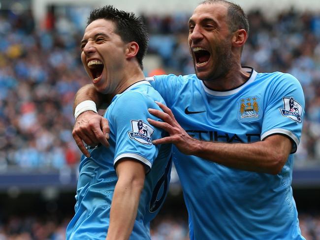 MANCHESTER, ENGLAND - MAY 11:  Samir Nasri of Manchester City celebrates scoring the first goal with team-mate Pablo Zabaleta (R) during the Barclays Premier League match between Manchester City and West Ham United at the Etihad Stadium on May 11, 2014 in Manchester, England.  (Photo by Alex Livesey/Getty Images)