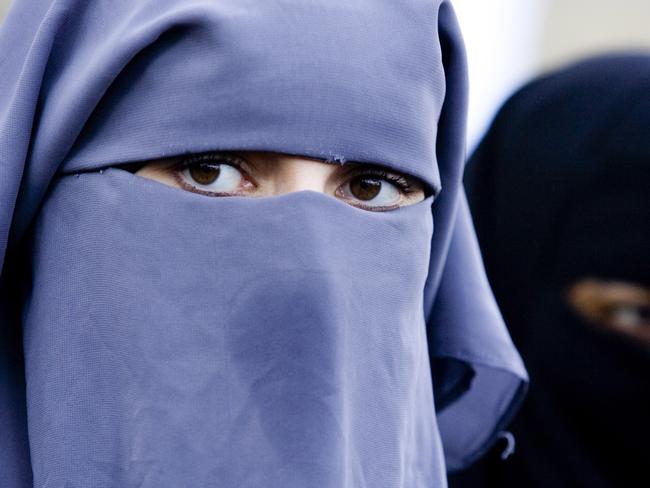 In this Thursday, Nov. 30, 2006 file photo unidentified women are seen wearing a niqab during a demonstration outside the Dutch parliament against a proposed ban on the burqa, in The Hague, Netherlands. Belgian politicians will vote on April 22, 2010 on whether to ban the burqa and other body and face covering attire. The proposed ban could become law by July and apply to all public places, including streets. Burqas. (AP Photo/ Fred Ernst, File)