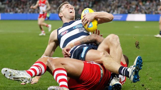 Joel Selwood’s ankle twists under Lance Franklin.