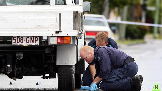 Police gather evidence at the scene of Omega Ruston’s shooting on Gold Coast Highway at Burleigh Heads.